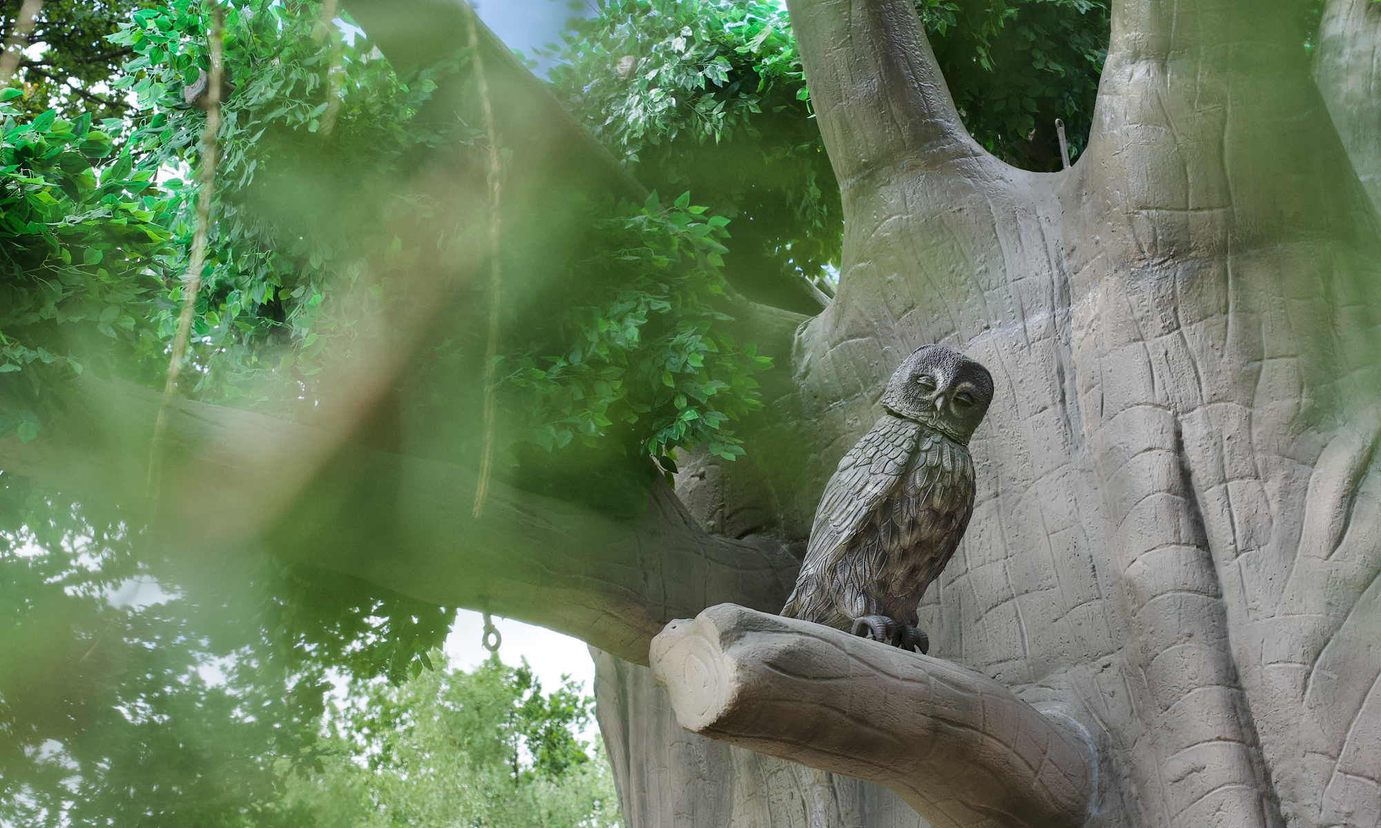 Decorative owl sitting on a branch.